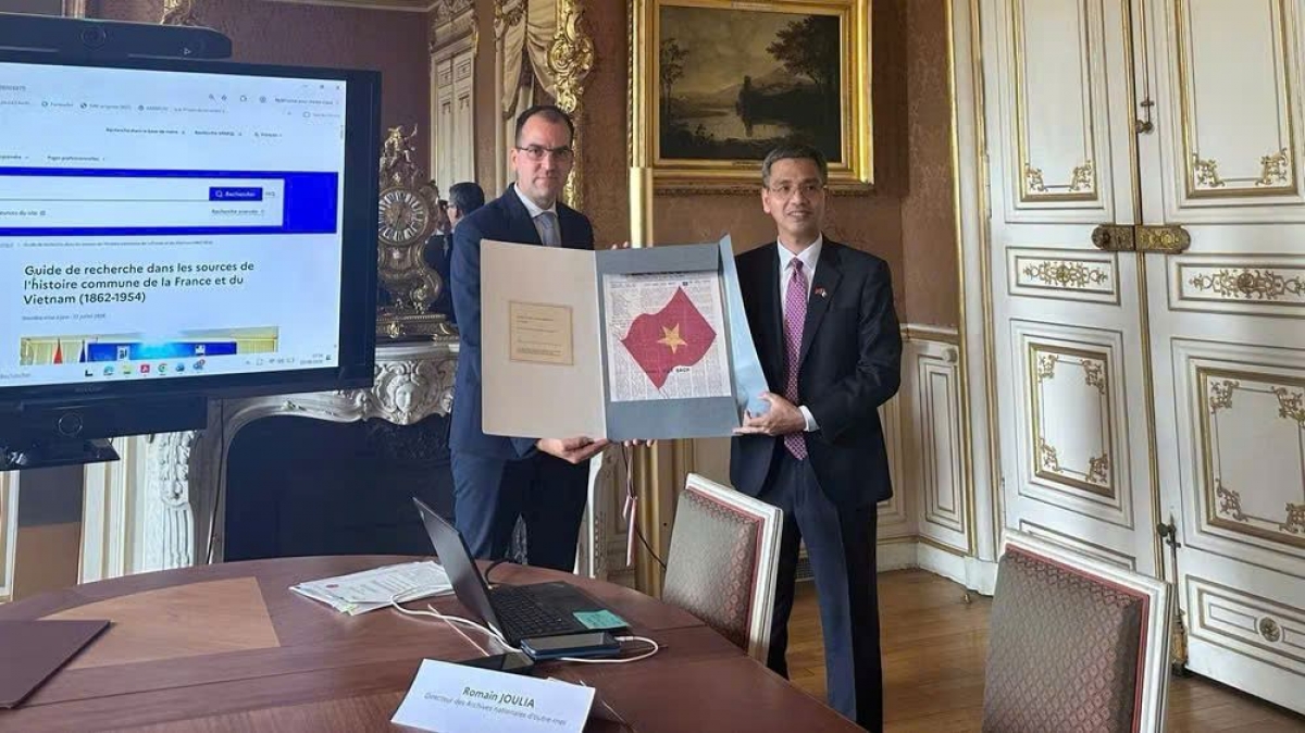  Le chef adjoint du Bureau du Comité central du Parti, Vo Thành Hung, reçoit des documents d’archives sur le Président Hô Chi Minh, remis par les Archives nationales d’outre-mer du ministère français de la Culture. Photo: TTXVN