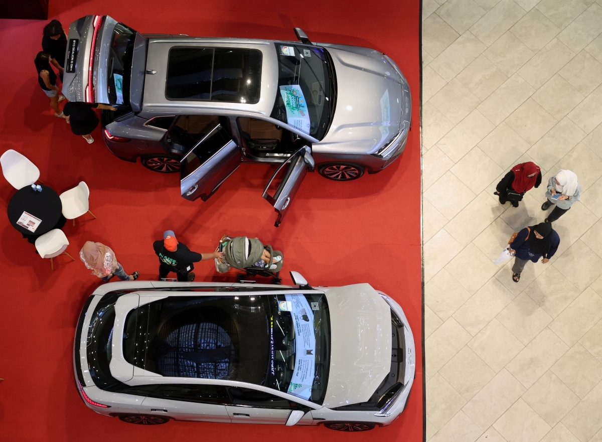 Người dân xem các mẫu xe điện BYD được trưng bày tại một triển lãm lưu động ở trung tâm thương mại tại Singapore ngày 30/3/2026. Ảnh: REUTERS/Edgar Su