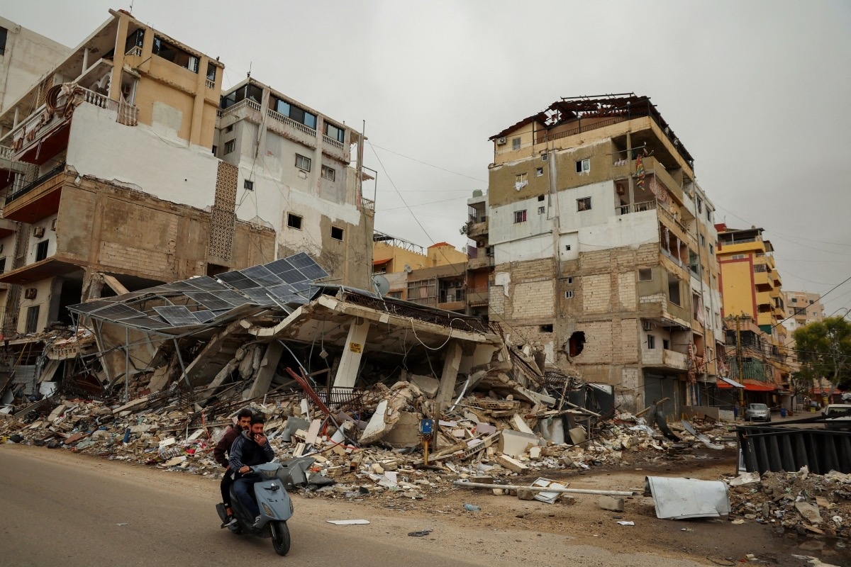 Men ride a scooter past the rubble of a building destroyed by an Israeli strike in Tyre, Lebanon, April 2, 2026. (Photo: REUTERS/Yara Nardi)
