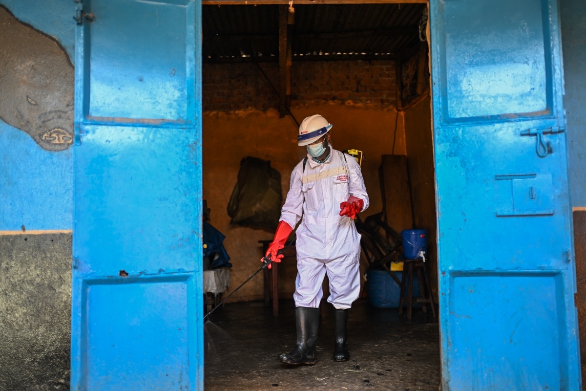 Seorang petugas kebersihan menyemprotkan disinfektan di pasar pusat saat provinsi Ituri terus berupaya mengatasi wabah Ebola, di Bunia, Kongo, 23 Mei 2026. Foto: AP/Moses Sawasawa