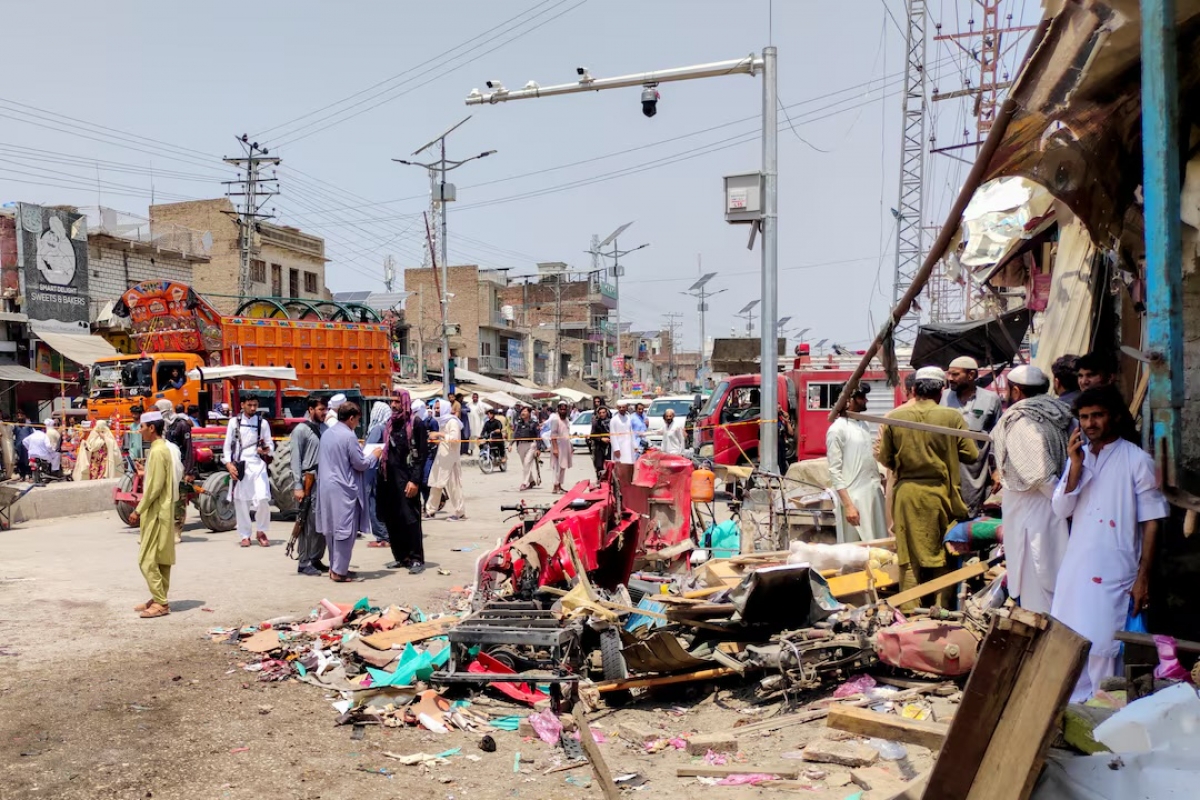 People and police officers in plain clothes gather after a blast at a market in Lakki Marwat, Khyber Pakhtunkhwa province, Pakistan, May 12, 2026. Picture taken with a mobile phone. (REUTERS/Syed Basit)