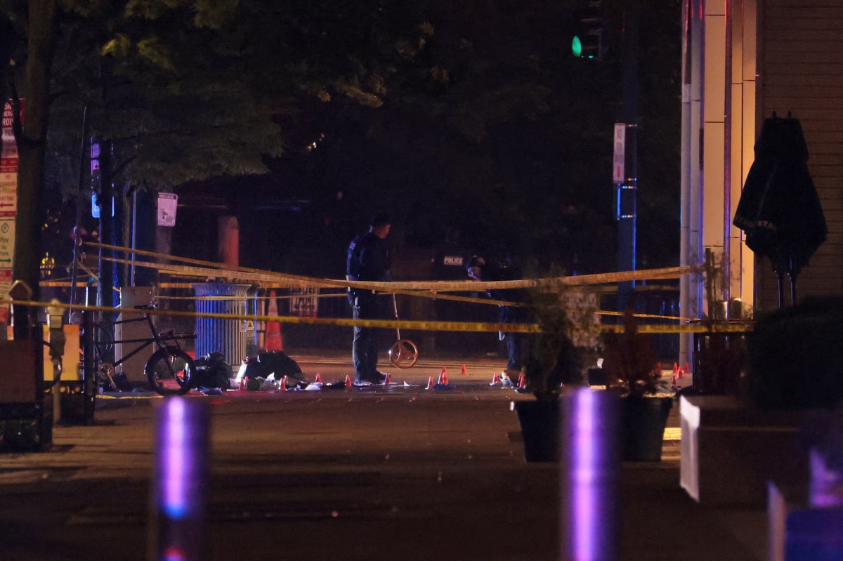 Law enforcement agents examine the evidence inside a cordoned off area on the street after a shooting incident near the White House in Washington, D.C., US, May 23, 2026. (REUTERS/Kylie Cooper)