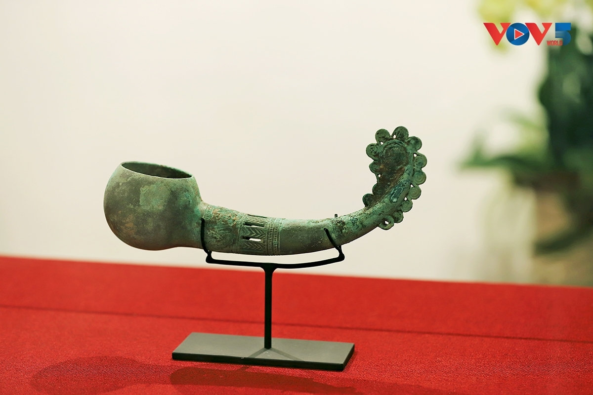 A bronze ladle intricately engraved with delicate decorative patterns.