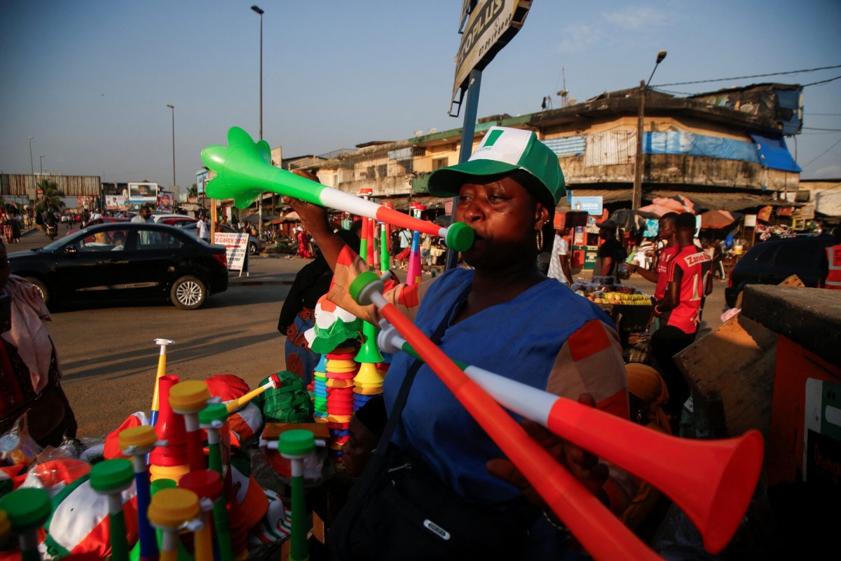 A vendor plays Vuvuzelas while people in Abidjan are getting excited as Ivory Coast gears up to host the Africa Cup of Nations in 2024. (REUTERS/Luc Gnago/File Photo)