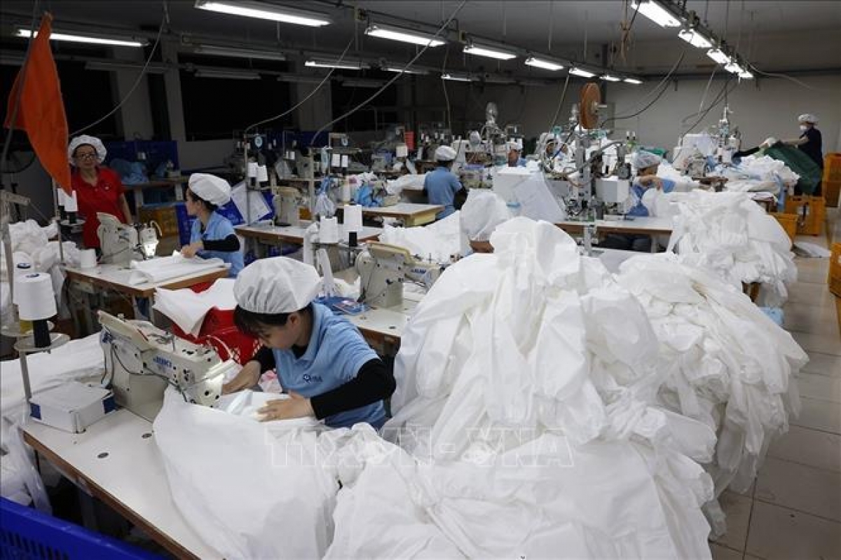 Workers manufacture protective garments for export at Japanese-owned Able Garment Industries Vietnam Ltd. in Phu Tai Industrial Park, Quy Nhon Bac Ward, Gia Lai province. (Photo: Vu Sinh/VNA)