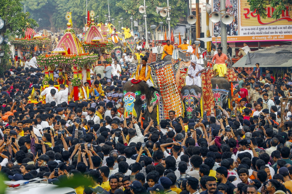 Devotees raise their hands to receive offerings as they participate in the annual chariot procession of Lord Jagannath, in Ahmedabad, Gujarat state, Thursday, July 16, 2026. (Photo: ANI)