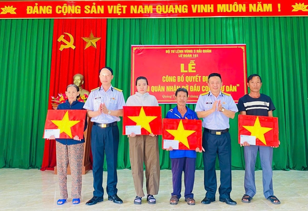 Chỉ huy Lữ đoàn 161 tặng quà ngư dân trong buổi trao quyết định nhận đỡ đầu con ngư dân tại xã Nam Gianh và xã Triệu Cơ. Ảnh: Lữ đoàn 161