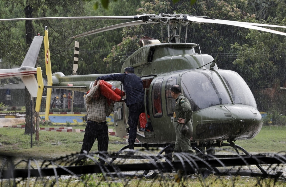 Rescuer load relief material in a helicopter to be transported to the areas affected by flash floods and a mudslide in Nepal. (Photo: Reuters)