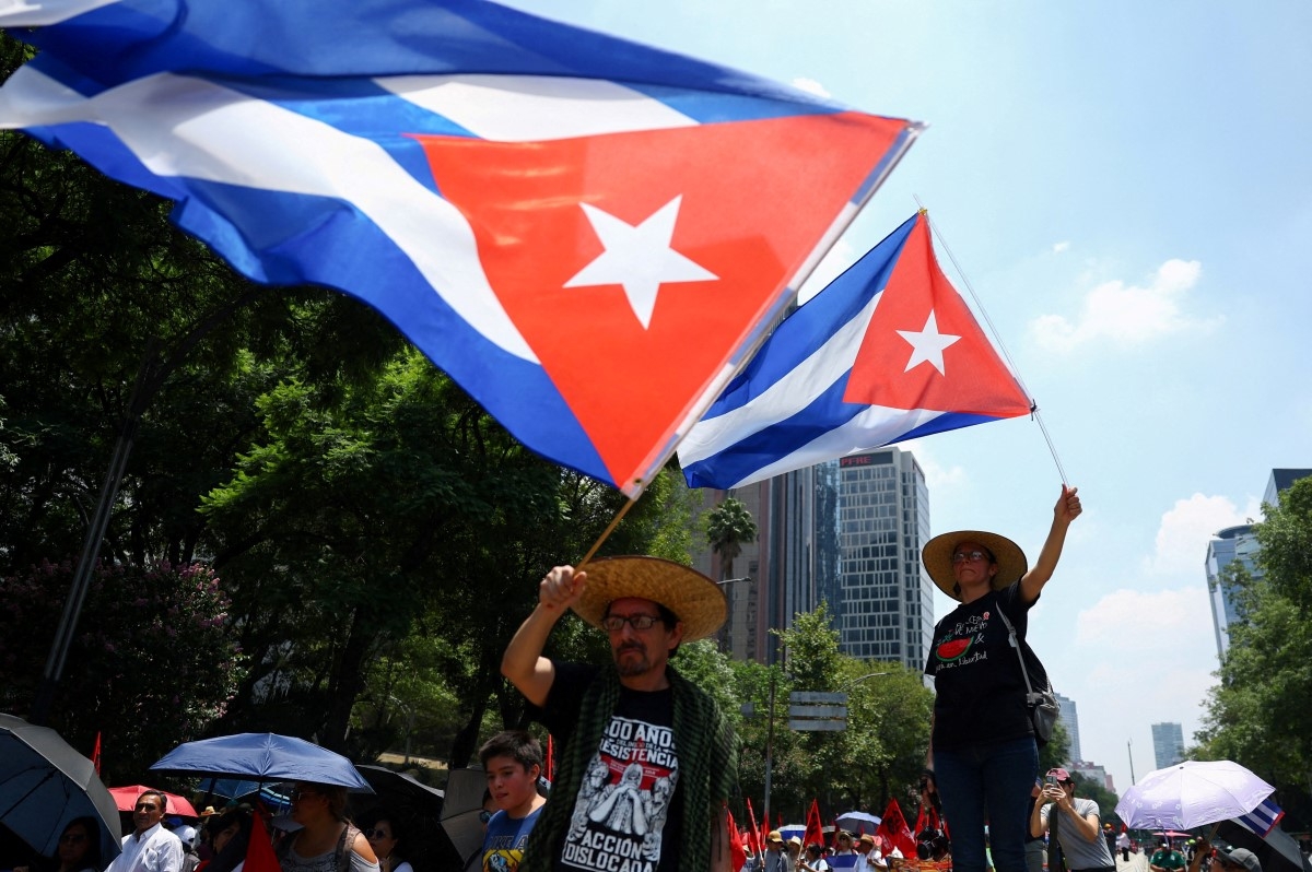 People wave Cuban flags during a protest against the US embargo on Cuba, marking Cuba's National Rebellion Day, in Mexico City, Mexico, July 26, 2026. (Photo: REUTERS/Daniel Becerril)