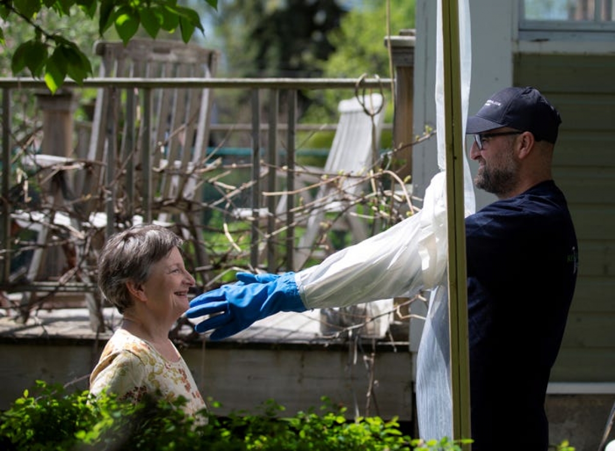 Before this year Alex Montagano's hugging station, a place designed specifically to embrace friends and family, might have appeared odd. Pictured is Montagano and his neighbor, Sharon Pearce-Anderson, using the hugging station. (Photo: Reuters/Christinne Muschi)
